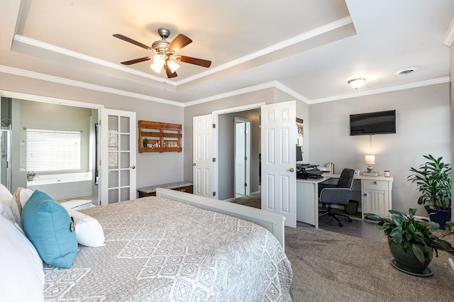 bedroom featuring carpet floors, a tray ceiling, ceiling fan, and ornamental molding