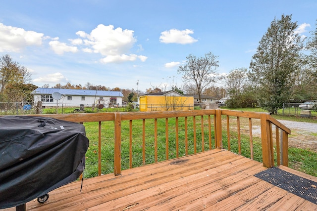 deck featuring a lawn and area for grilling