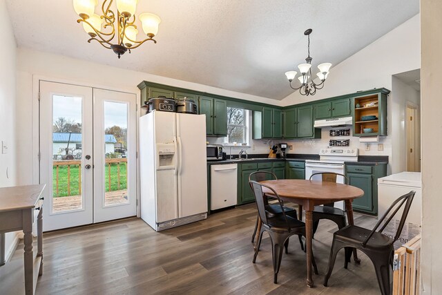 kitchen featuring vaulted ceiling, white appliances, hanging light fixtures, and a chandelier