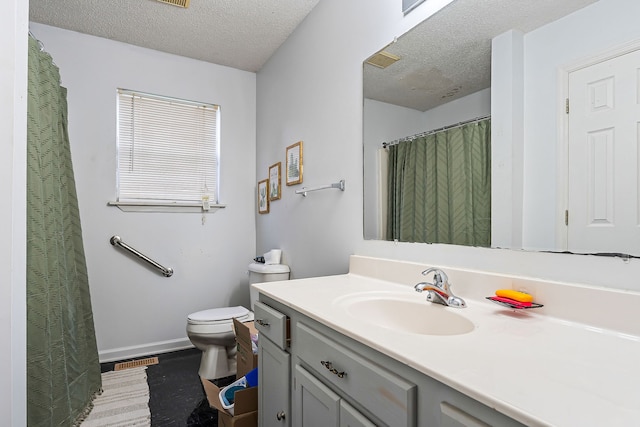 bathroom featuring vanity, toilet, wood-type flooring, and a textured ceiling