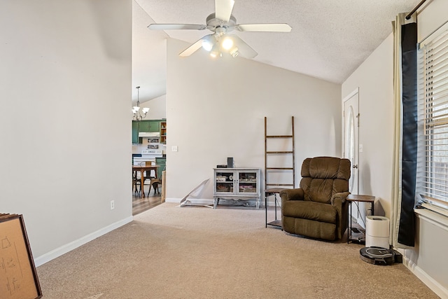 living area featuring carpet, ceiling fan with notable chandelier, and vaulted ceiling