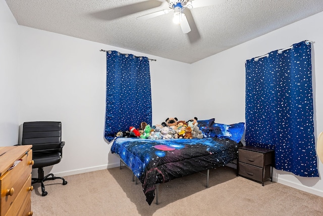 carpeted bedroom featuring a textured ceiling and ceiling fan