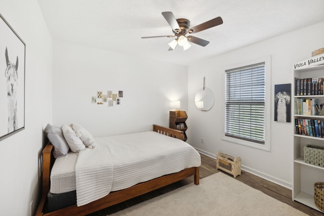 bedroom featuring ceiling fan and wood-type flooring