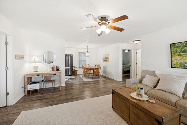 living room with dark hardwood / wood-style floors and ceiling fan