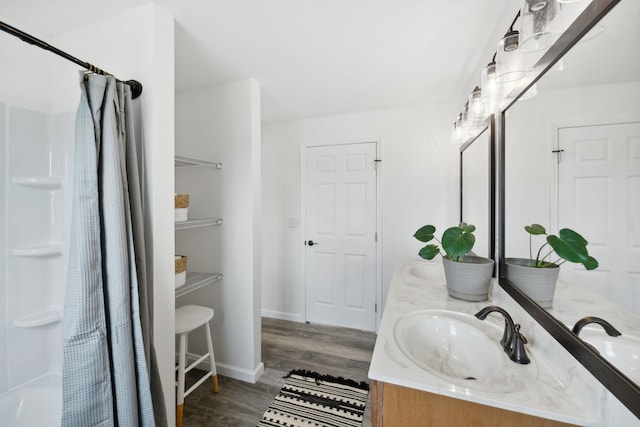 bathroom with hardwood / wood-style floors, vanity, and a shower with shower curtain