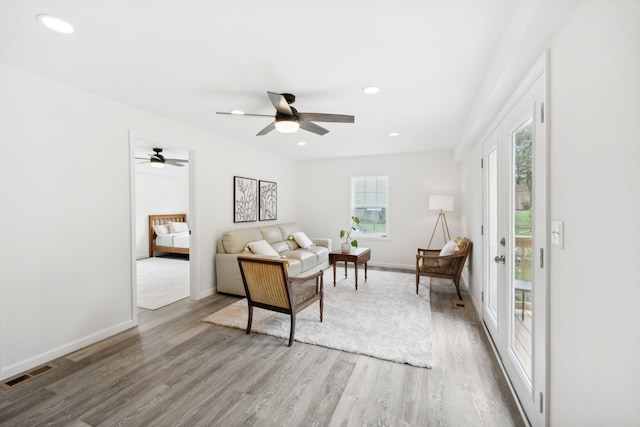 living room with ceiling fan and hardwood / wood-style flooring