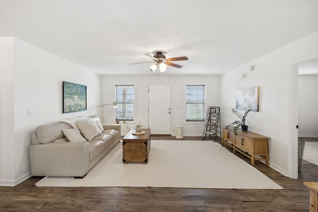 living room featuring hardwood / wood-style floors and ceiling fan