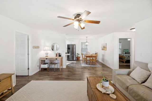 living room with ceiling fan and dark hardwood / wood-style floors