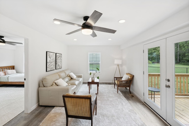 living room featuring hardwood / wood-style floors, ceiling fan, and french doors