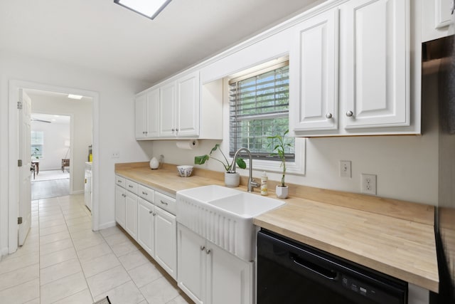 kitchen featuring dishwasher, white cabinets, wooden counters, and sink