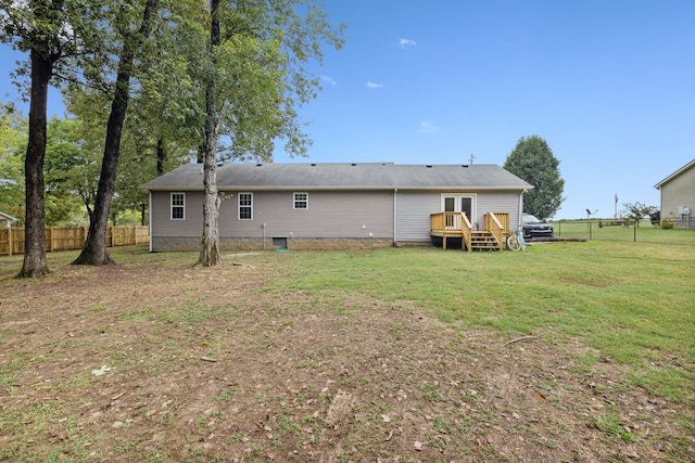 back of house with a yard and a deck