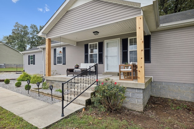 view of exterior entry with a porch