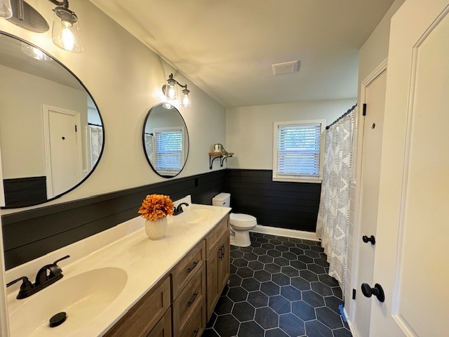 bathroom featuring tile patterned floors, vanity, and toilet