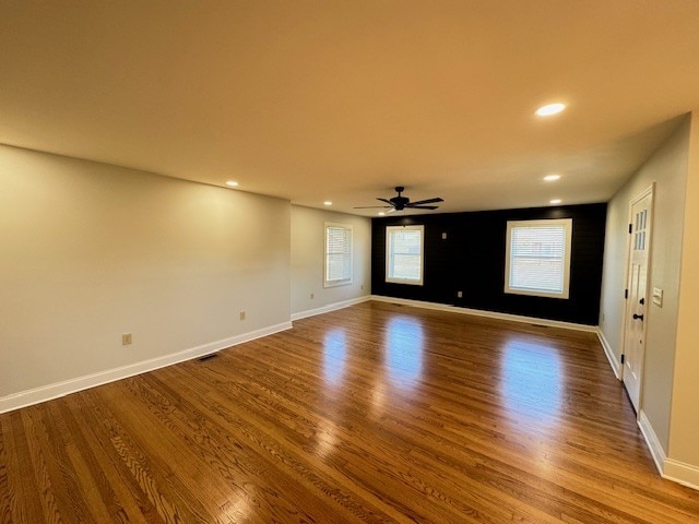 empty room featuring hardwood / wood-style floors and ceiling fan