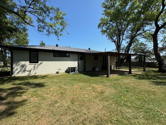 rear view of house with a lawn