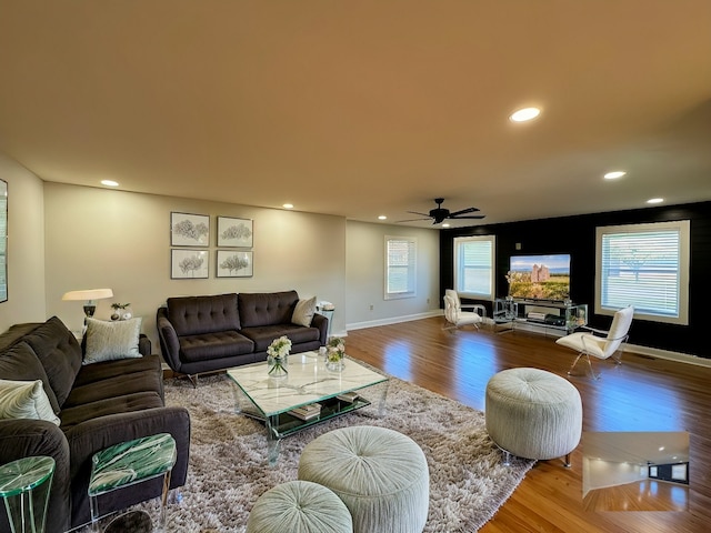 living room with hardwood / wood-style flooring and ceiling fan