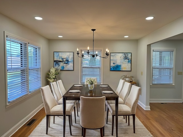 dining room featuring hardwood / wood-style flooring and a notable chandelier