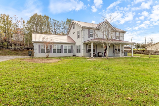 rear view of property with a lawn