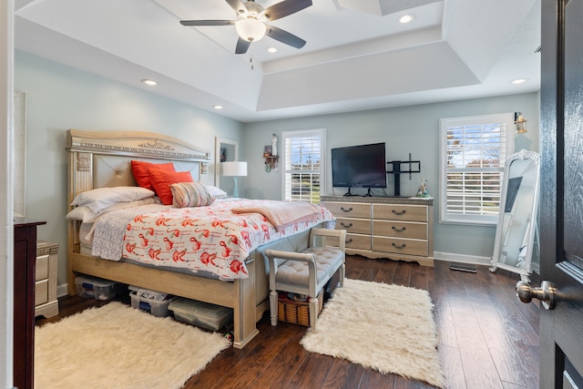 bedroom with dark hardwood / wood-style flooring, multiple windows, and ceiling fan