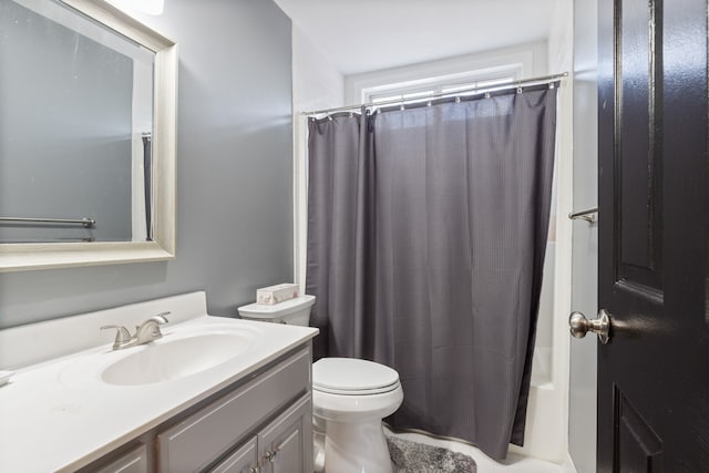 full bathroom featuring shower / tub combo, vanity, and toilet