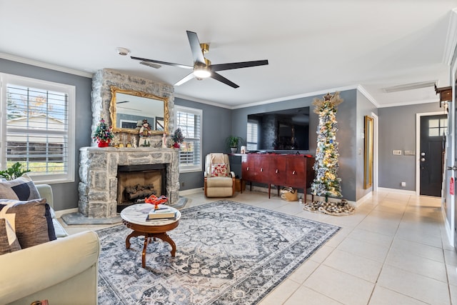 living room with ceiling fan, a fireplace, a healthy amount of sunlight, and ornamental molding