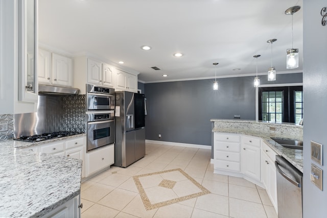 kitchen with white cabinetry, light stone counters, decorative light fixtures, and appliances with stainless steel finishes