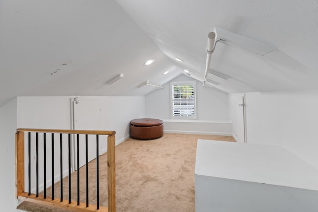 additional living space featuring light carpet and lofted ceiling