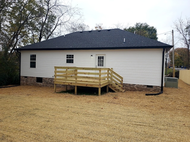 back of property with a wooden deck