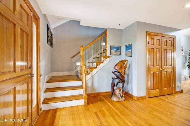 staircase with hardwood / wood-style flooring