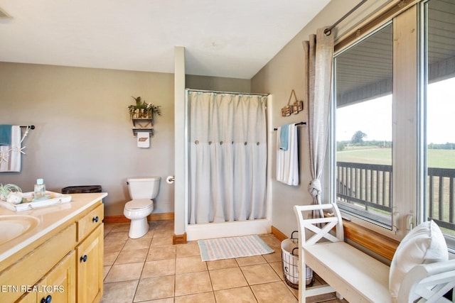 bathroom with tile patterned flooring, vanity, curtained shower, and toilet