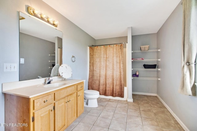 full bathroom featuring shower / bath combo with shower curtain, tile patterned flooring, vanity, and toilet