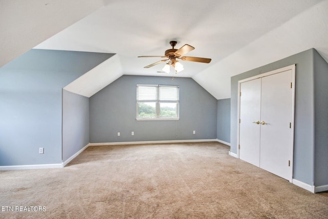 bonus room with ceiling fan, light carpet, and vaulted ceiling