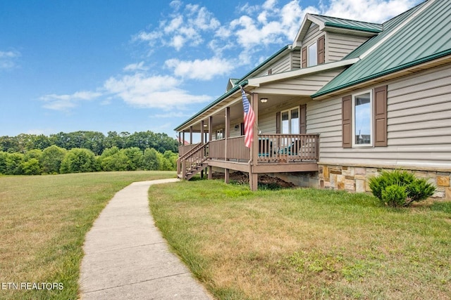 view of side of property featuring a yard and a porch