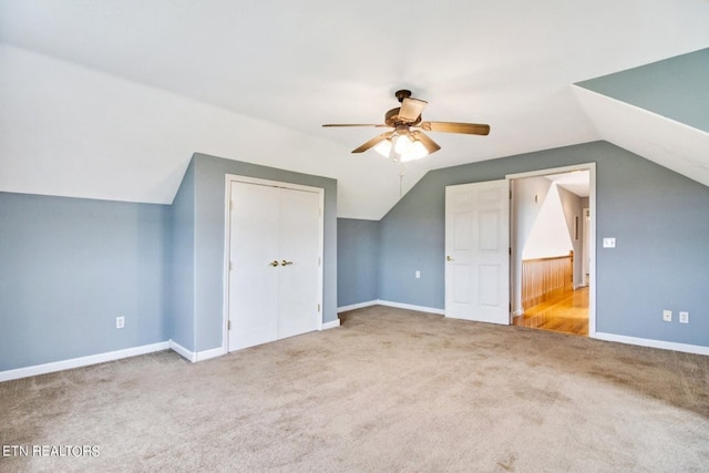 additional living space with carpet, ceiling fan, and vaulted ceiling