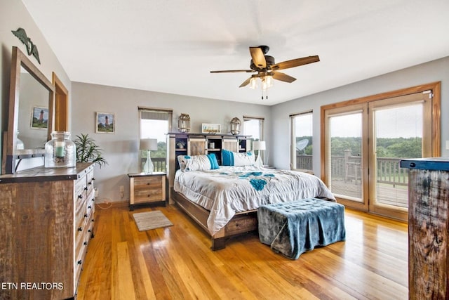 bedroom with hardwood / wood-style floors, ceiling fan, access to exterior, and multiple windows