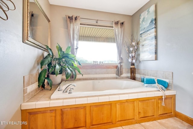 bathroom featuring tile patterned flooring and a tub to relax in