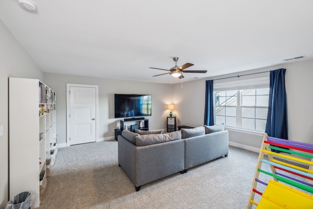 living room with light carpet and ceiling fan