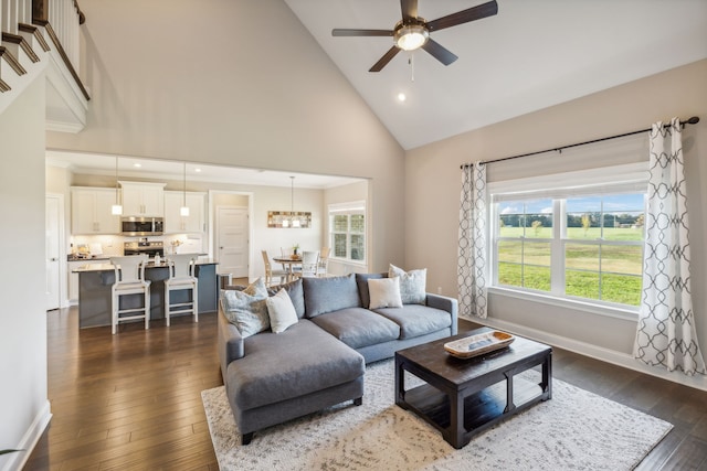 living room featuring plenty of natural light, high vaulted ceiling, and dark hardwood / wood-style floors