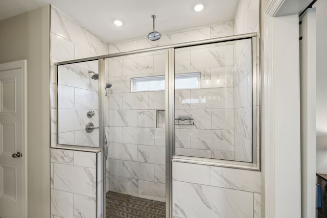 bathroom with a shower with shower door