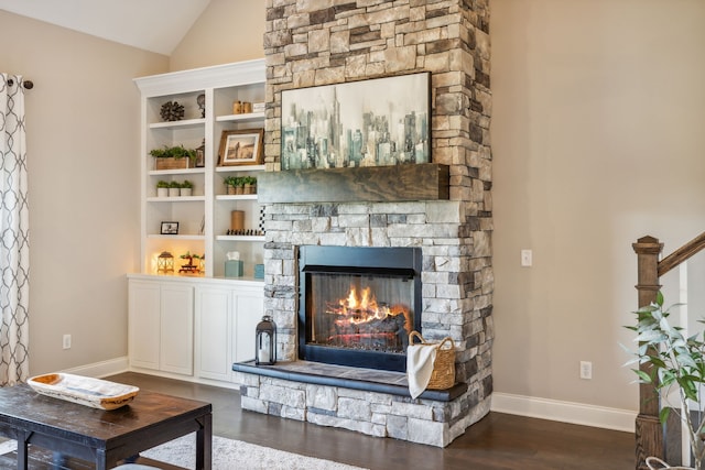 interior space featuring a fireplace, dark hardwood / wood-style flooring, and vaulted ceiling