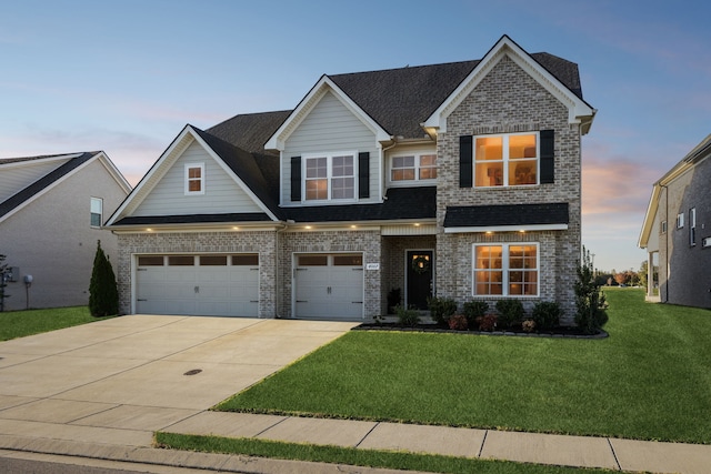 craftsman-style home featuring a yard and a garage