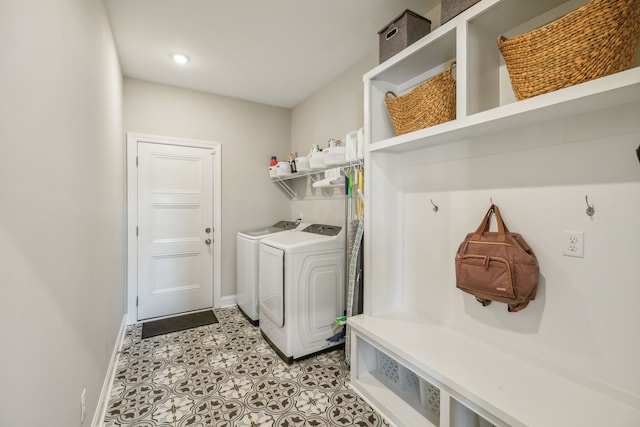 laundry room with light tile patterned flooring and washing machine and clothes dryer