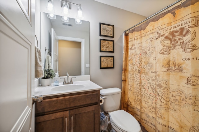 bathroom with vanity, curtained shower, and toilet