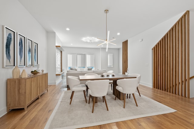 dining area featuring a chandelier and light hardwood / wood-style flooring