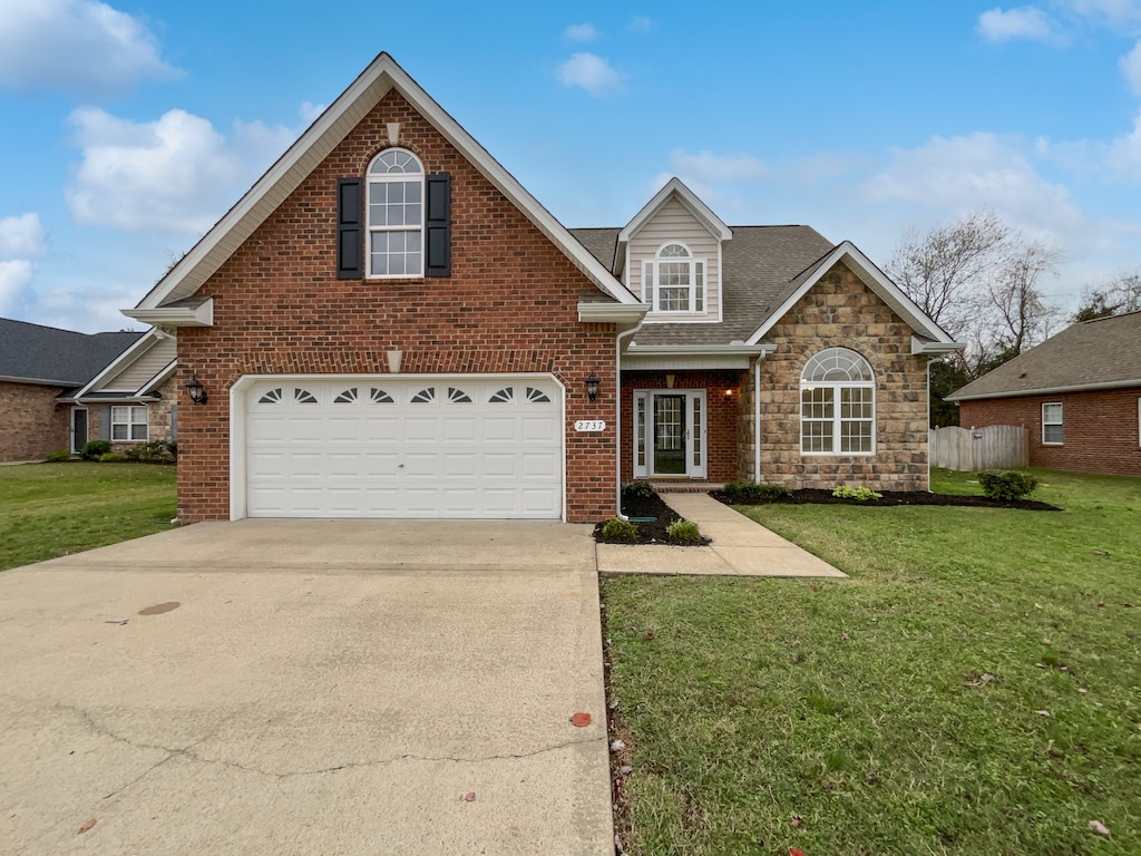 view of front property featuring a garage and a front lawn