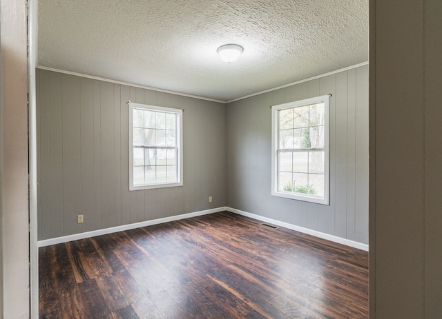 spare room with wood walls, dark hardwood / wood-style flooring, and ornamental molding