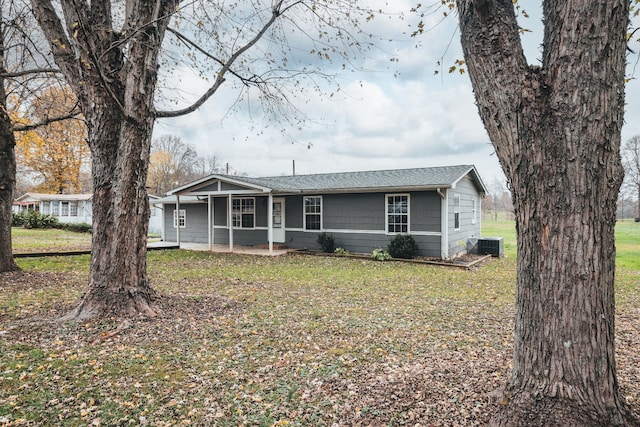 single story home with a front lawn and central AC unit