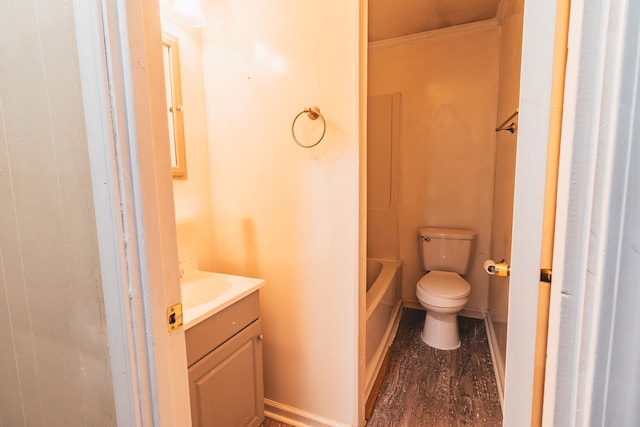 bathroom featuring a bath, hardwood / wood-style floors, vanity, and toilet