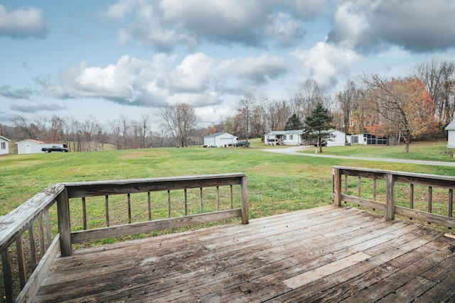 wooden deck featuring a yard