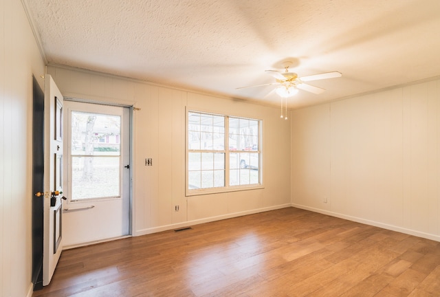 interior space with hardwood / wood-style floors, a textured ceiling, ceiling fan, and ornamental molding